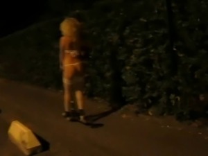 young blonde girl half-naked down the street with kickboard