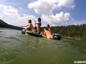 Frisky and playful girls swimming in the lake naked