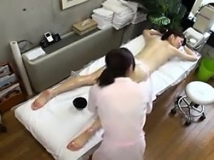 Elegant Oriental lady has a masseuse greasing up her marvel