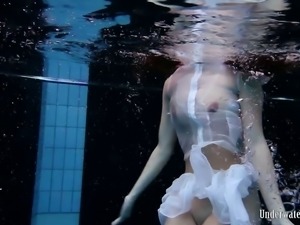 Busty sizzling hot brunette teen undressing underwater