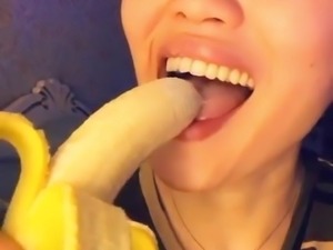 horny asian kazakh chick sucking banana