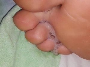 Spitting on girlfriends feet
