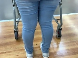 Short Latina in blue jeans with nice booty standing in line