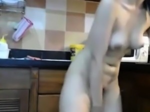 Cute Asian chick attempts to handle Ohmibod in kitchen